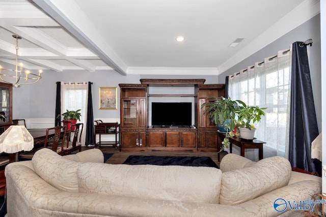 living area featuring a chandelier, ornamental molding, a wainscoted wall, and beam ceiling