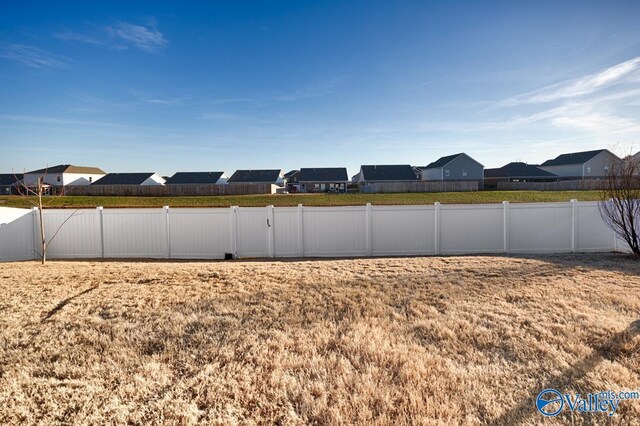 view of yard with fence and a residential view