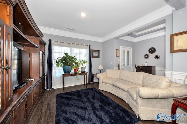 living area featuring crown molding, visible vents, and dark wood-type flooring