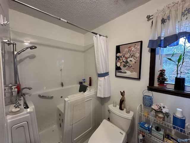 bathroom with toilet and a textured ceiling