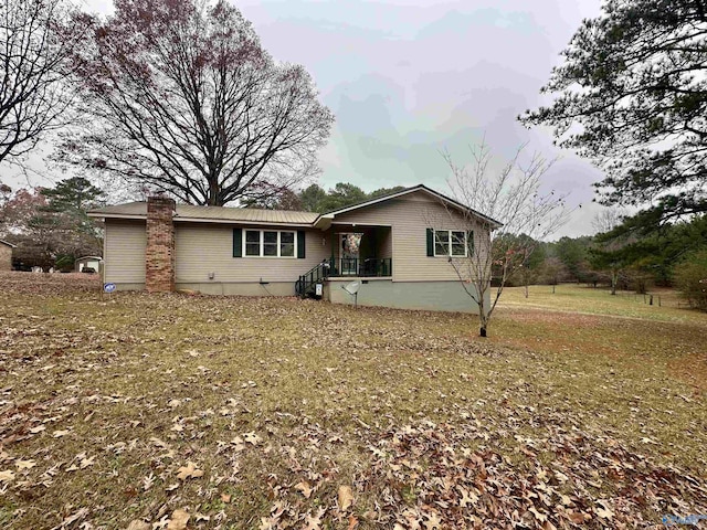 rear view of property featuring a yard