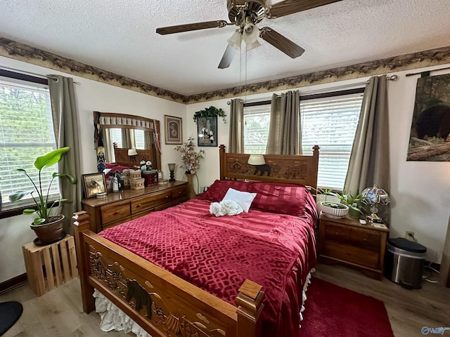 bedroom featuring ceiling fan, a textured ceiling, and hardwood / wood-style flooring