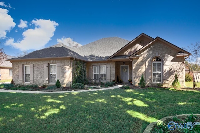 2609 Quarter Ln, Owens Cross Roads, AL 35763 - ranch-style home featuring brick siding, a shingled roof, and a front lawn