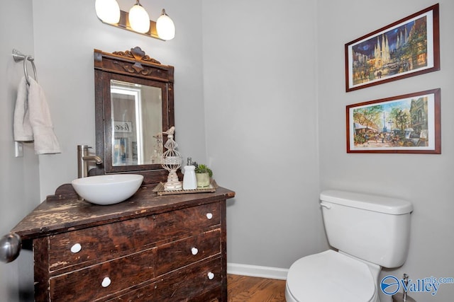 2609 Quarter Ln, Owens Cross Roads, AL 35763 - bathroom with vanity, baseboards, wood finished floors, and toilet