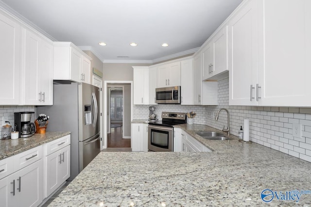 2609 Quarter Ln, Owens Cross Roads, AL 35763 - kitchen with white cabinets, light stone countertops, a sink, stainless steel appliances, and tasteful backsplash