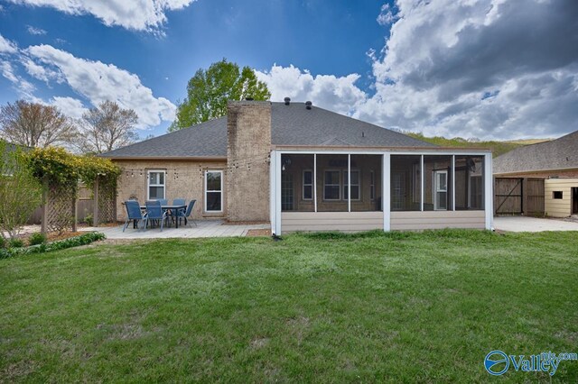 2609 Quarter Ln, Owens Cross Roads, AL 35763 - back of house featuring fence, a sunroom, a chimney, a lawn, and a patio