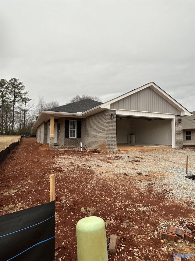 view of front facade featuring a garage, driveway, and brick siding