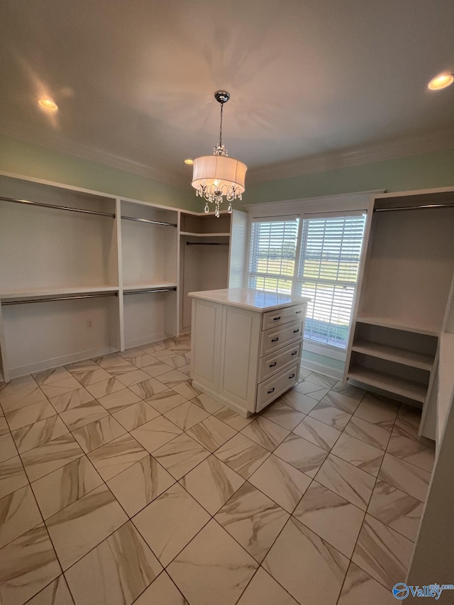 spacious closet with an inviting chandelier