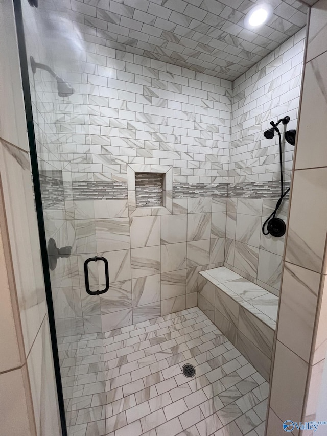 bathroom with a shower with shower door