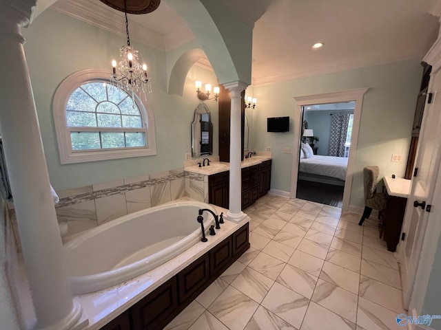 bathroom with an inviting chandelier, ornate columns, a washtub, ornamental molding, and vanity