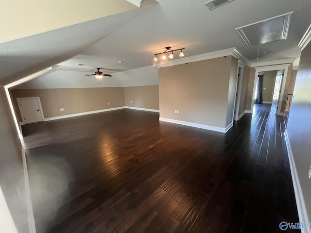 interior space featuring ceiling fan, lofted ceiling, crown molding, and dark wood-type flooring