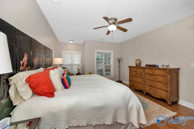 bedroom with ceiling fan and wood-type flooring