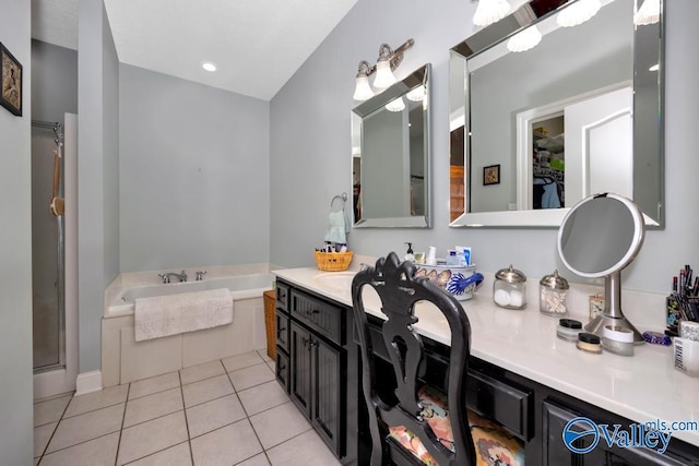 bathroom with tile patterned floors, vanity, and a washtub