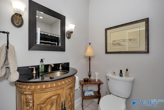 bathroom featuring vanity, tile patterned flooring, and toilet