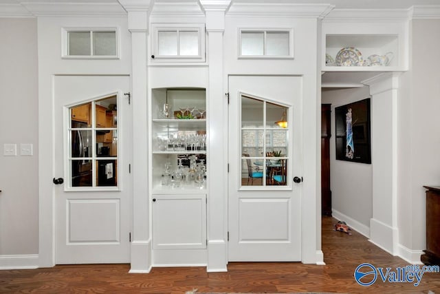 interior space with hardwood / wood-style flooring and crown molding