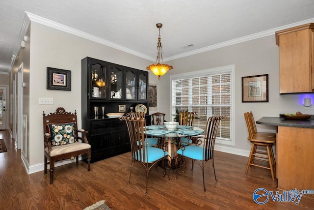 dining space with ornamental molding and dark wood-type flooring