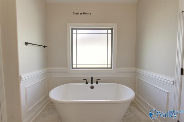FLAGSTAFF-B Newby Chapel Rd, Athens, AL 35613 - full bathroom with a freestanding bath, a wainscoted wall, tile patterned flooring, and a decorative wall