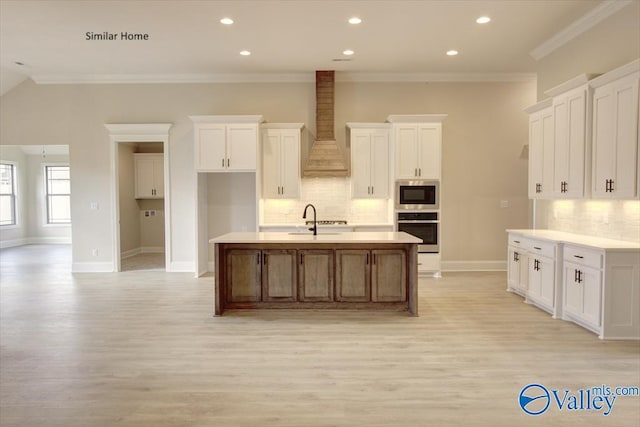 FLAGSTAFF-B Newby Chapel Rd, Athens, AL 35613 - kitchen featuring wall chimney range hood, light wood-style floors, tasteful backsplash, crown molding, and recessed lighting