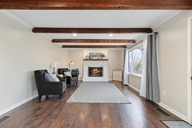 4018 SE Piedmont Dr, Huntsville, AL 35802 - sitting room with dark wood-style flooring, visible vents, beam ceiling, and a brick fireplace