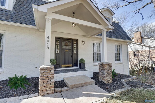 4018 SE Piedmont Dr, Huntsville, AL 35802 - view of exterior entry featuring roof with shingles, covered porch, and brick siding