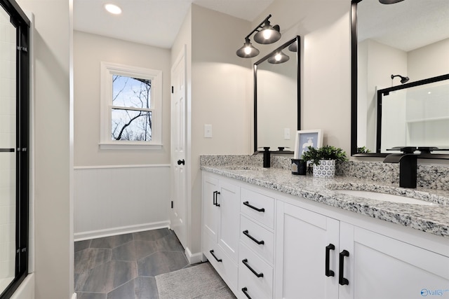 4018 SE Piedmont Dr, Huntsville, AL 35802 - full bathroom with a sink, an enclosed shower, double vanity, and wainscoting