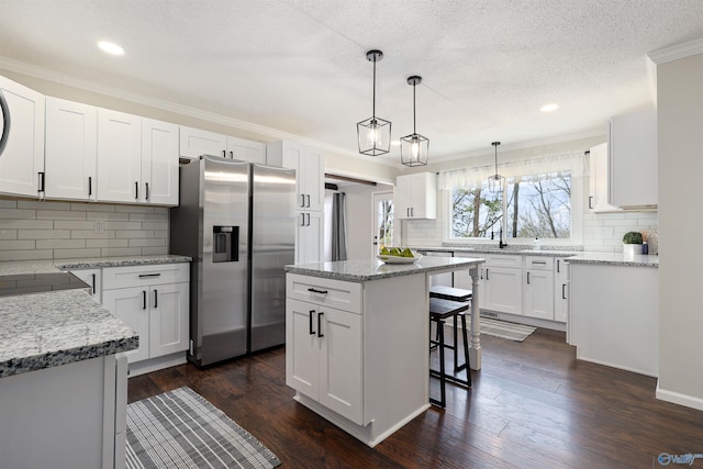 4018 SE Piedmont Dr, Huntsville, AL 35802 - kitchen featuring stainless steel fridge with ice dispenser, backsplash, recessed lighting, and a kitchen island