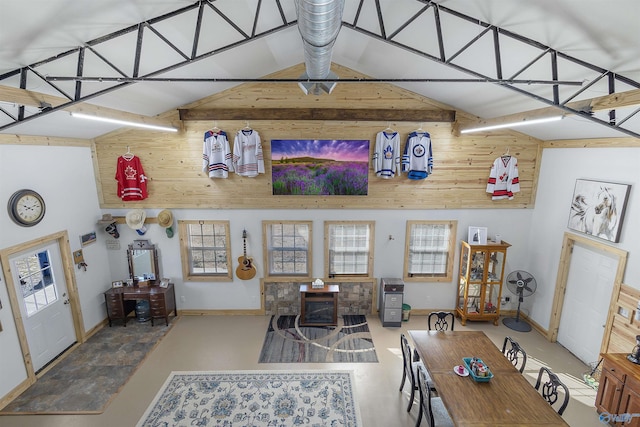 dining area featuring high vaulted ceiling