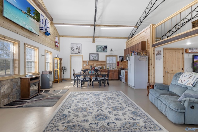 living room with a towering ceiling and sink