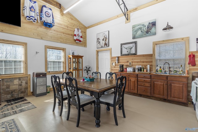 dining area with high vaulted ceiling and sink