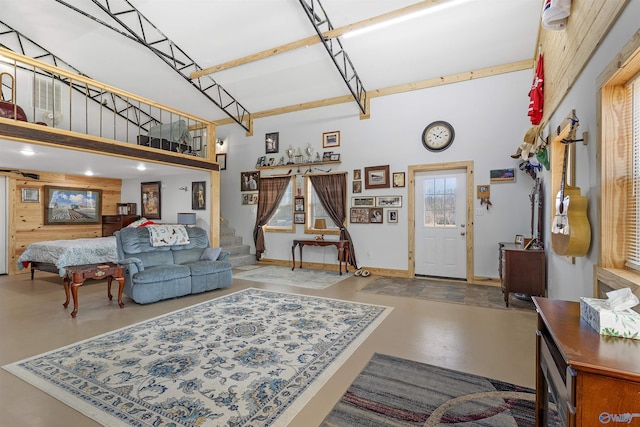 living room featuring concrete flooring and a towering ceiling