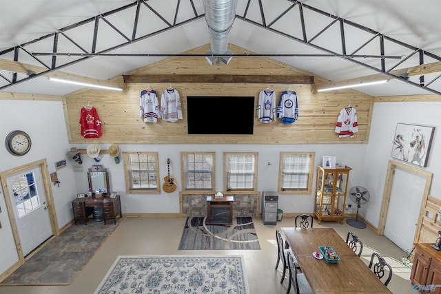 dining area with high vaulted ceiling