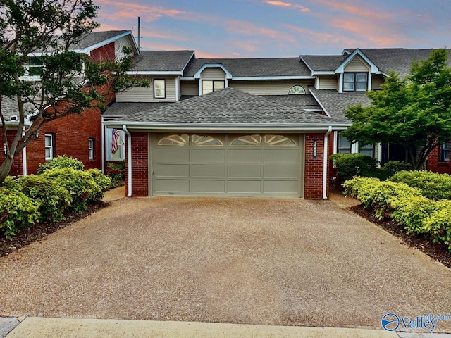 10003 Meredith Ln SE, Huntsville, AL 35803 - view of property featuring driveway, an attached garage, a shingled roof, and brick siding