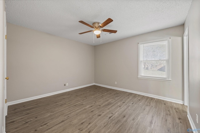 13935 SW Wyandotte Dr, Huntsville, AL 35803 - empty room with wood finished floors, a ceiling fan, and a textured ceiling
