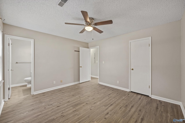 13935 SW Wyandotte Dr, Huntsville, AL 35803 - unfurnished bedroom with wood finished floors, connected bathroom, a textured ceiling, and ceiling fan