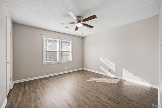 13935 SW Wyandotte Dr, Huntsville, AL 35803 - unfurnished room with wood finished floors, a ceiling fan, and a textured ceiling