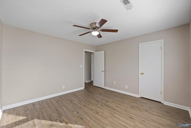 13935 SW Wyandotte Dr, Huntsville, AL 35803 - unfurnished bedroom featuring light wood-style flooring, a ceiling fan, and a textured ceiling