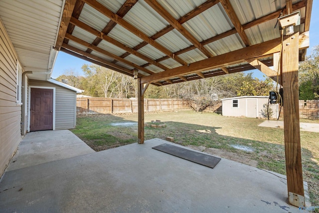 13935 SW Wyandotte Dr, Huntsville, AL 35803 - fenced backyard featuring a patio area and an outbuilding