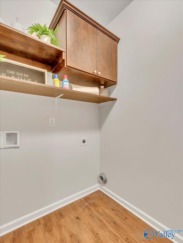 27004 Mill Creek Dr, Athens, AL 35613 - laundry room featuring hookup for an electric dryer, baseboards, light wood-style flooring, and cabinet space