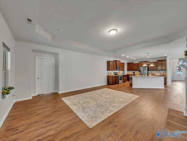 27004 Mill Creek Dr, Athens, AL 35613 - living area with visible vents, a chandelier, dark wood-style floors, and a raised ceiling