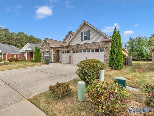 27004 Mill Creek Dr, Athens, AL 35613 - view of front of home with an attached garage, brick siding, a front yard, and concrete driveway