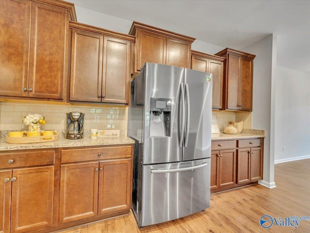 27004 Mill Creek Dr, Athens, AL 35613 - kitchen featuring backsplash, stainless steel refrigerator with ice dispenser, and brown cabinets