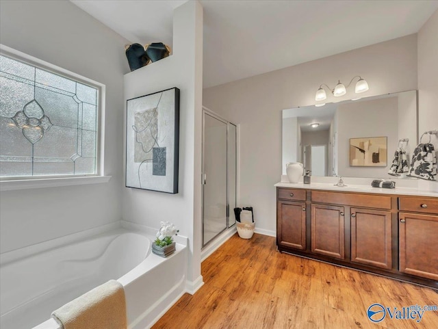 27004 Mill Creek Dr, Athens, AL 35613 - full bath with vanity, a stall shower, a bath, and wood finished floors