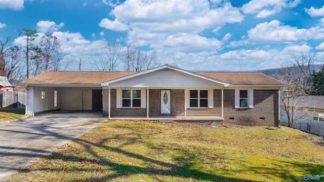 ranch-style home featuring a front lawn, covered porch, and a carport