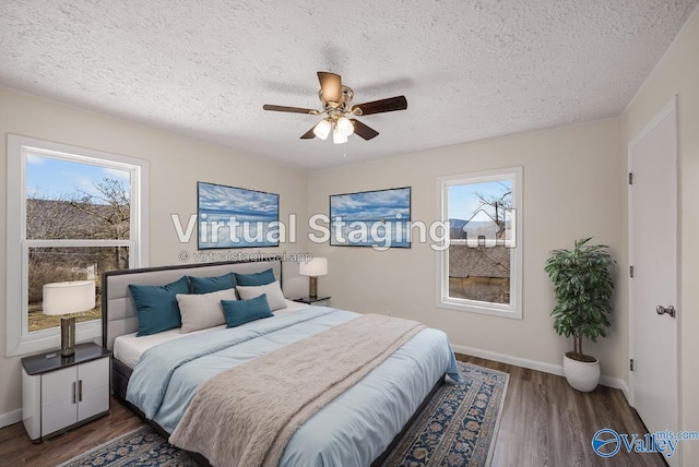 bedroom featuring ceiling fan, dark hardwood / wood-style floors, and a textured ceiling