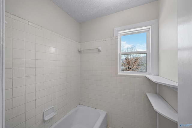 bathroom featuring a textured ceiling and tile walls