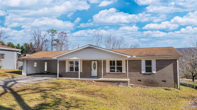 single story home featuring a carport, covered porch, and a front lawn