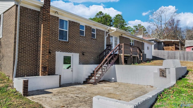 view of front of house with central AC and a patio