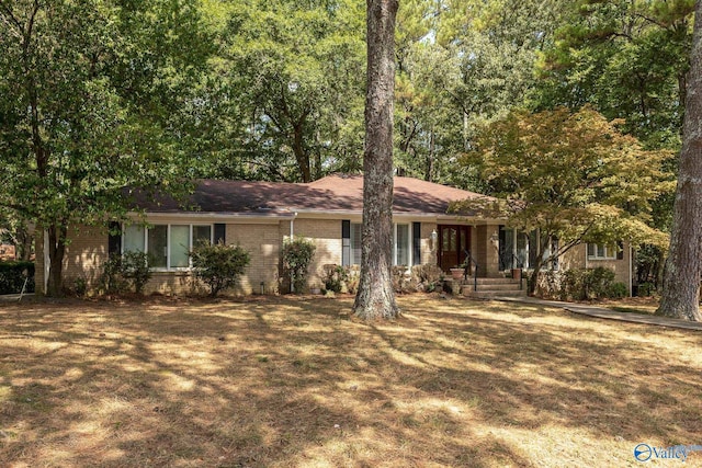 ranch-style home with a front lawn