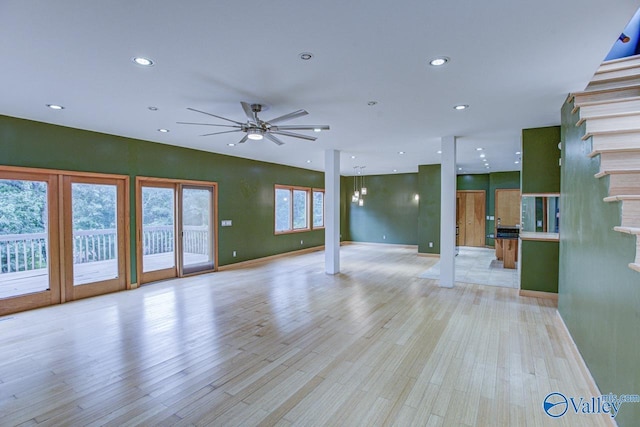 unfurnished living room with ceiling fan and light wood-type flooring