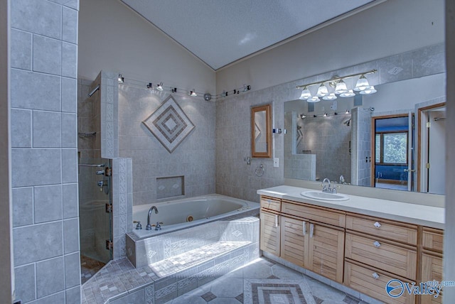 bathroom featuring shower with separate bathtub, vaulted ceiling, vanity, tile patterned floors, and a textured ceiling